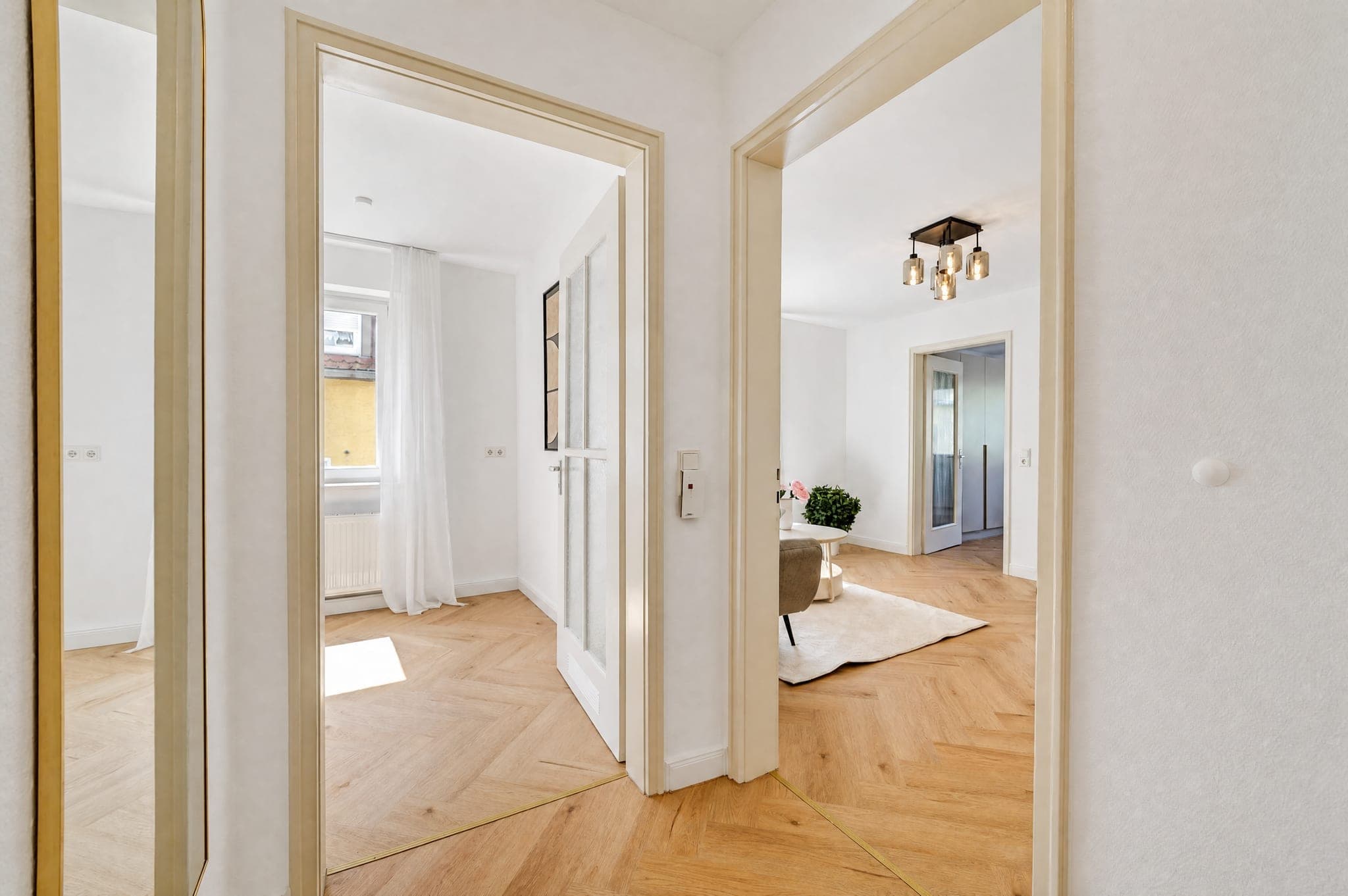 Hallway with open doors and a view into two adjoining rooms