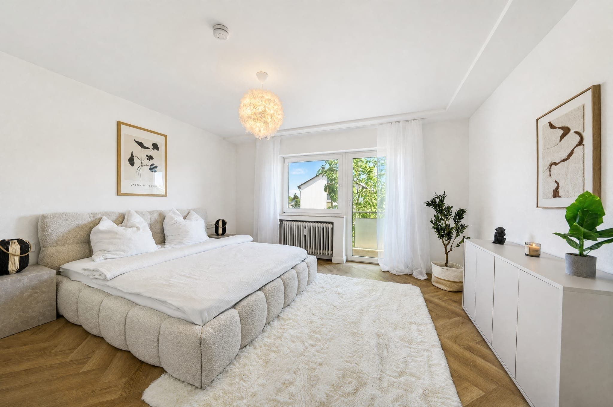 Bedroom with an upholstered bed, deep-pile rug and a balcony door behind a sheer curtain