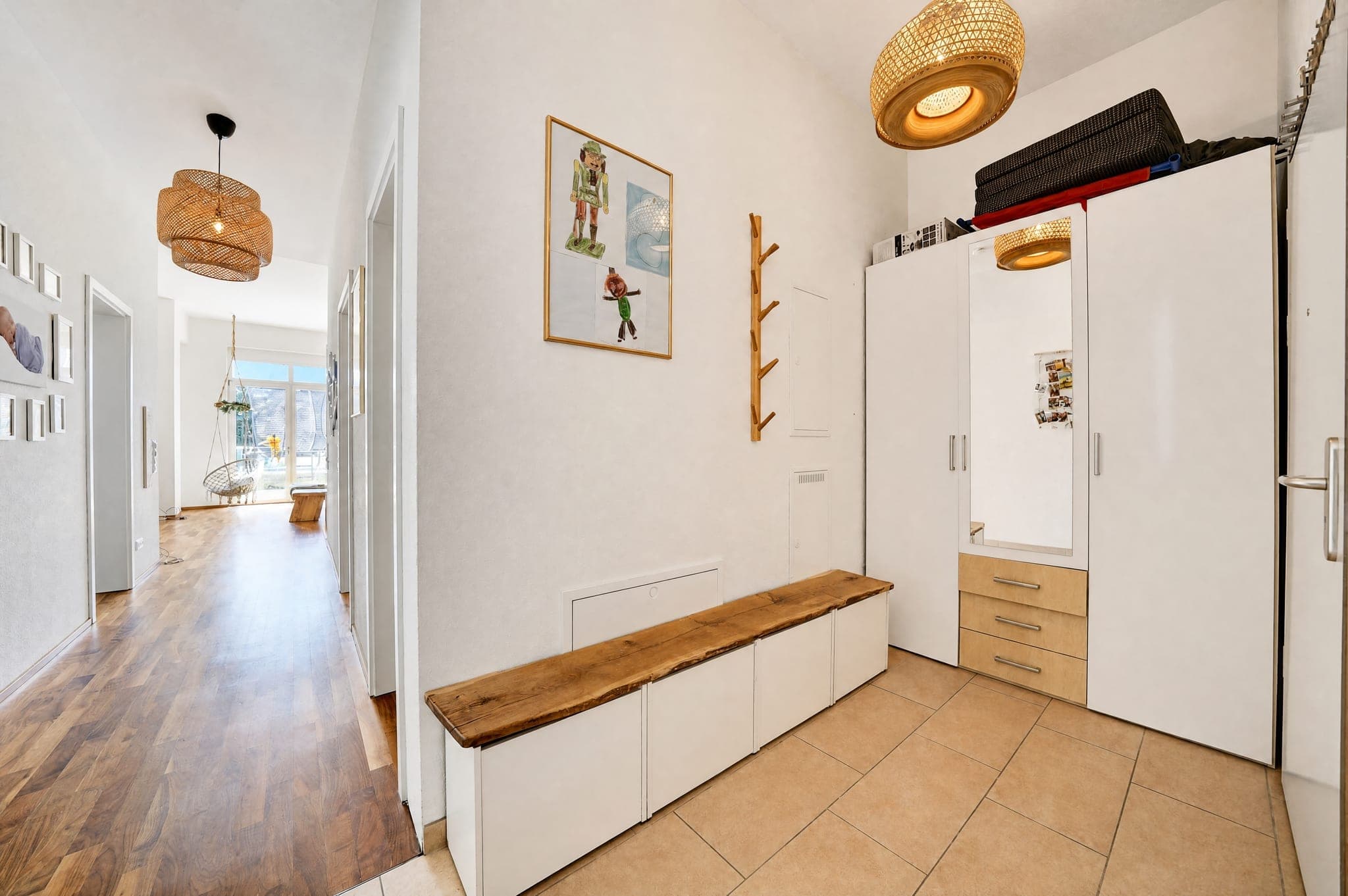 Hallway with a solid wood bench, wardrobe unit and passage through to the living area